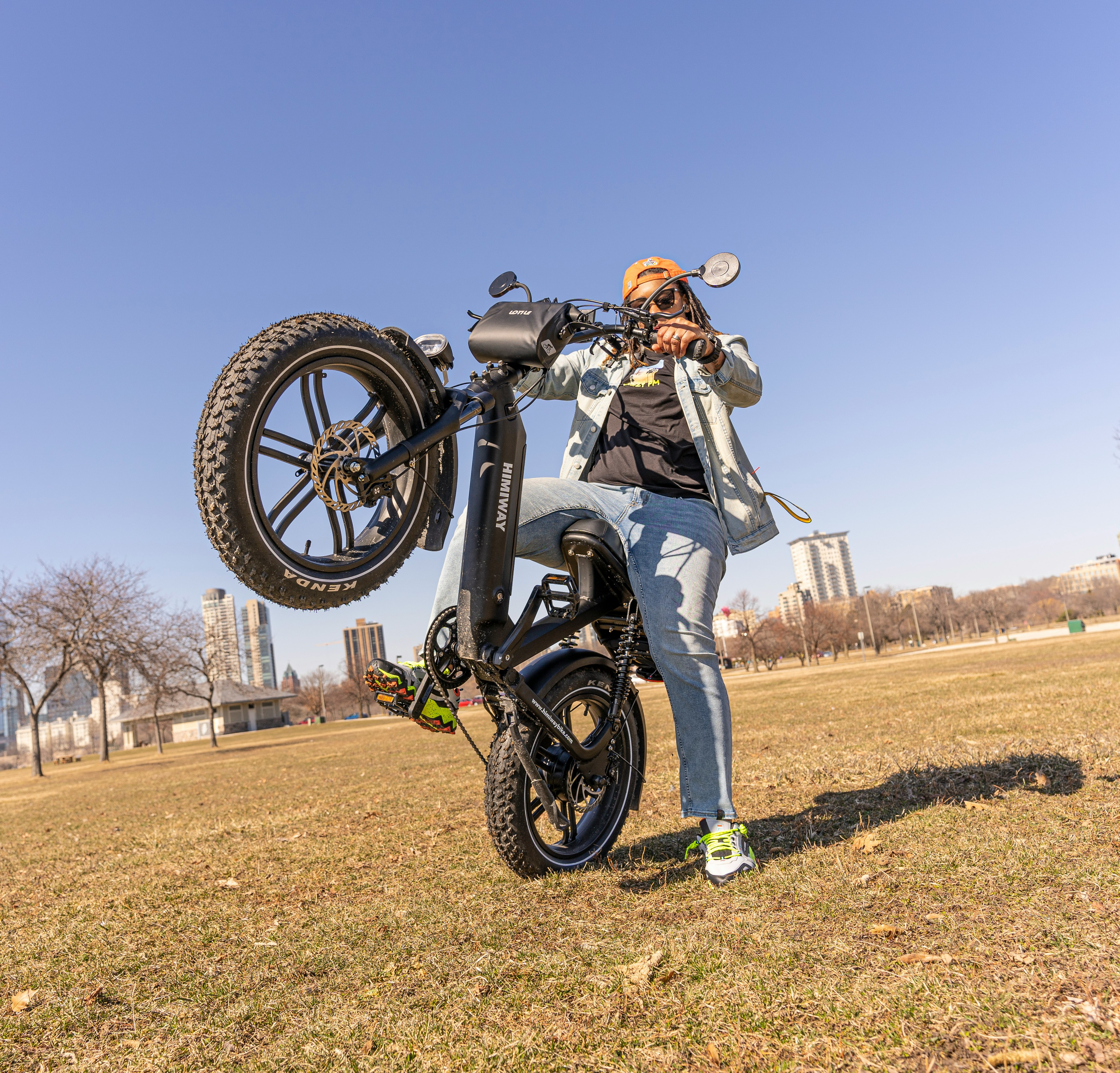 man in white shirt riding on white dirt bike on brown field during daytime